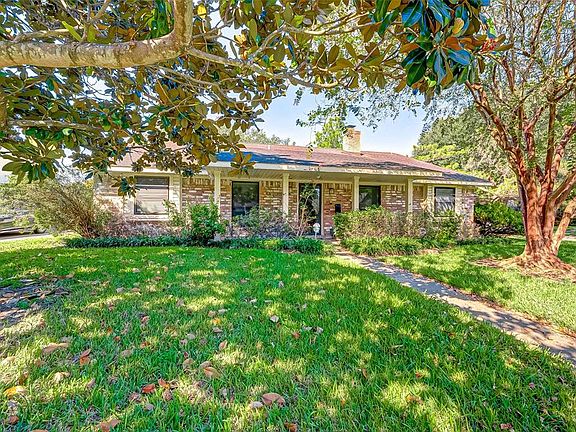 Mature trees and beautiful landscaping as you walk up to 7702 Colony St.