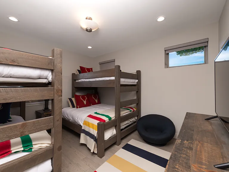 Spacious bunk room with a cozy sitting area and private ensuite