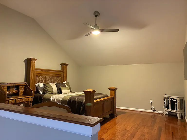 Master Bedroom 1 with electric fireplace and writing table.