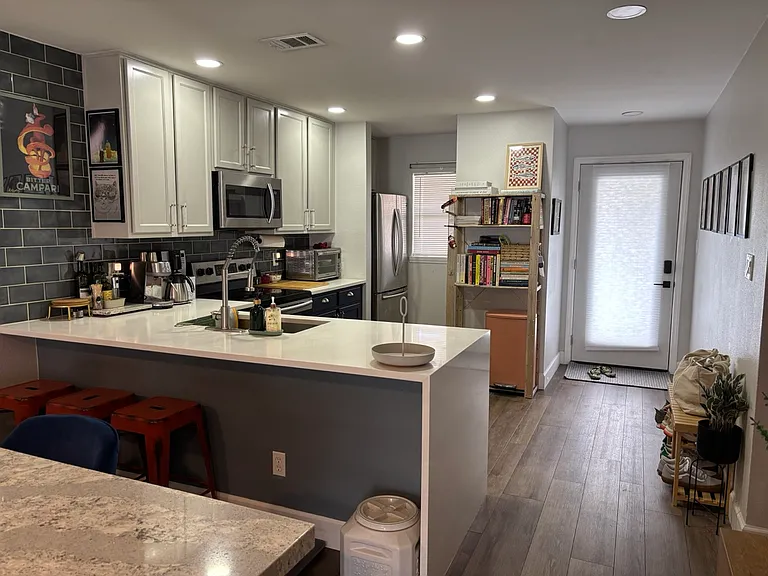 Front door, kitchen, bar seating