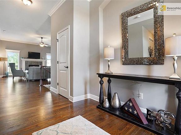 Step inside to the large foyer with high ceilings, crown molding, and hardwood floors.