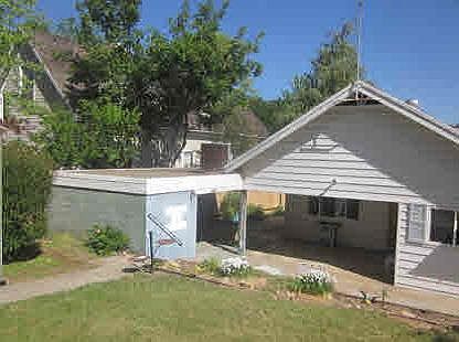 Back of house with storage shed