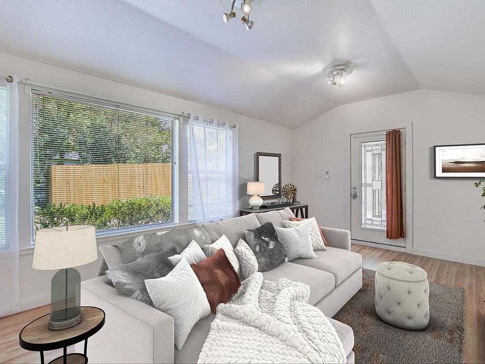 The spacious living room boasts high ceilings and a view of your private, lush backyard with no neighbors in sight, creating a peaceful and serene atmosphere!