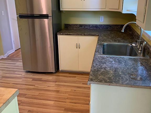 Kitchen with new refrigerator, new floors, new countertop, sink