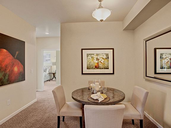 A cozy dining area with overhead lighting and easy access to the kitchen