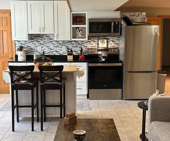 Full sized refrigerator/freezer, microwave, range, oven all less than 2 years old.