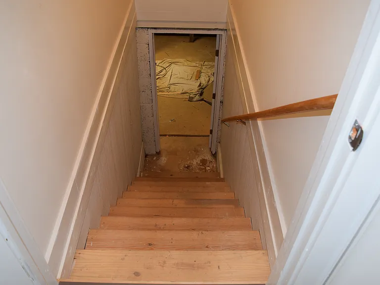 Stairs to basement. Basement is dry and suitable for storage