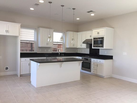 kitchen with granite counter top, tile flooring