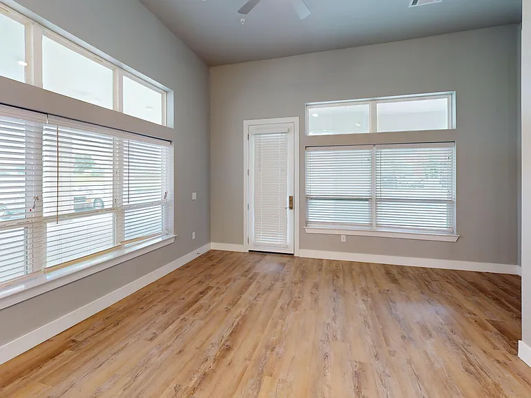 The Bellview living room includes wood-style flooring and large windows. The Bellview living room includes wood-style flooring and large windows.