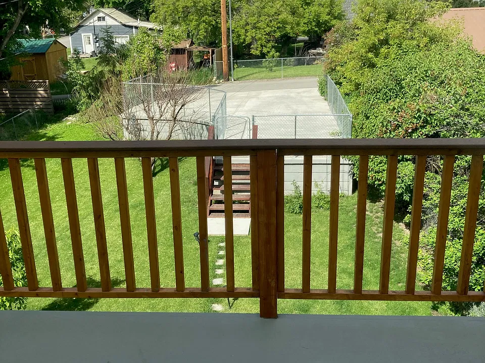 Looking down from the deck to yard and parking.
