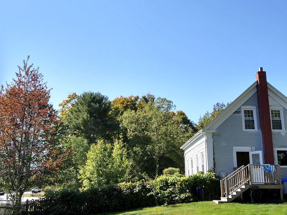 Open back yard with gardens and fruit trees