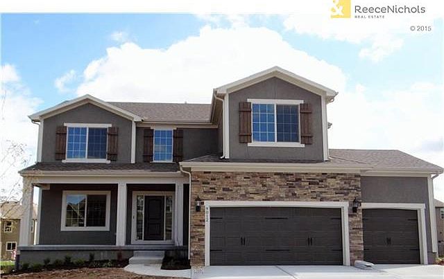 The "Pebblebrook: with stucco and stone accents with inviting front porch.