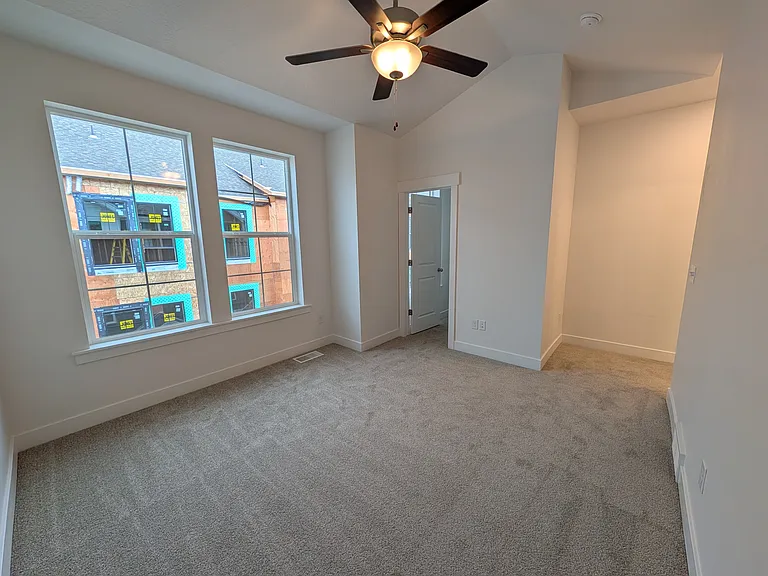 Master bedroom with large windows, walk in closet and a master bath.