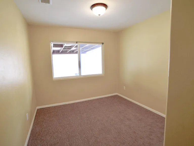Back Bedroom w/closet and View of Backyard/Covered Patio