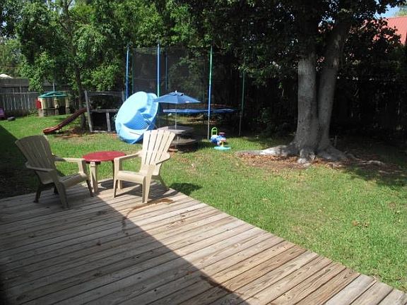 Fenced in backyard w/deck