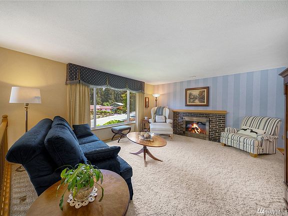 Get cozy around the wood burning fireplace this winter in your large living room!