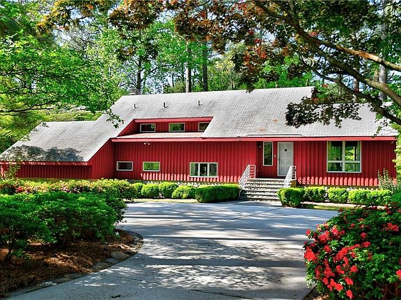 Welcome to Quiet Cove, a custom designed and built one owner home. Don't worry about backing out of the driveway because it is circular. There is room for four huge vehicles on the front parking pad.  The roomy front porch is begging you to come visit!