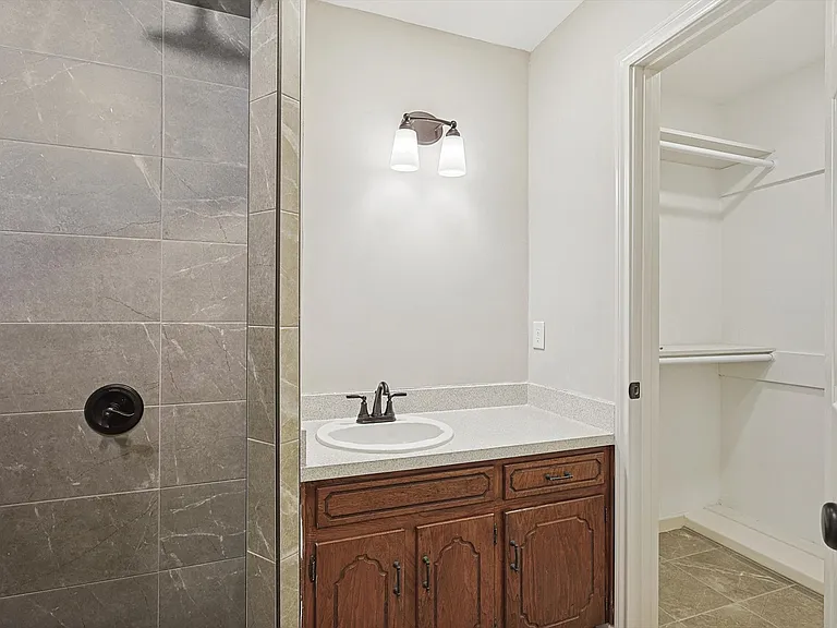 Primary walk in closet and shower. Mirror has been installed.