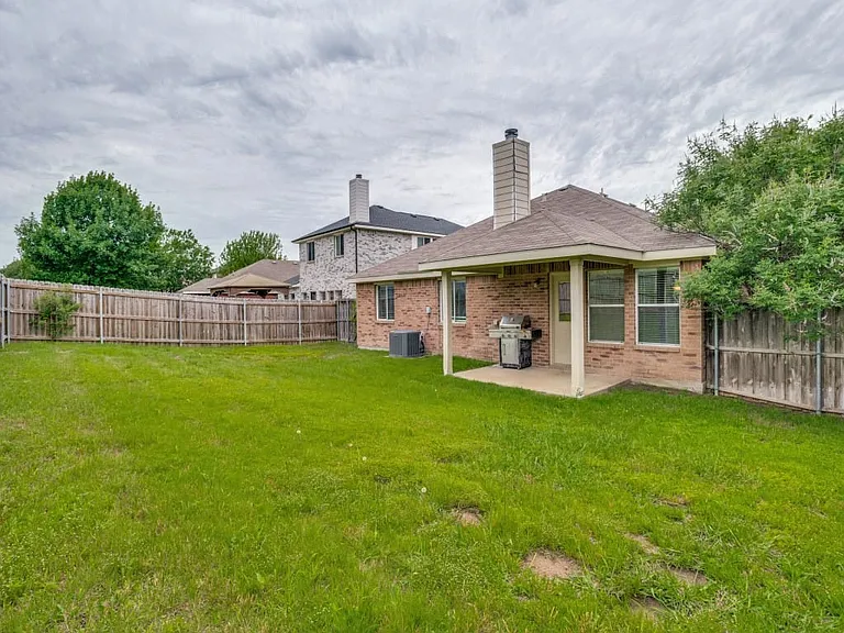Large private backyard with side gate leading to front yard.