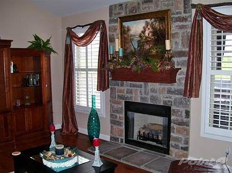 Truly a masterpiece! This floor to ceiling stone Gas Burning Fireplace flanked by large windows with Plantation Shutters is easily the focal point of the Great Room! The Stone and Hardwood in this room merges with the outdoor lake views from the windows, a wonderful harmonious blend of function and natural beauty!
