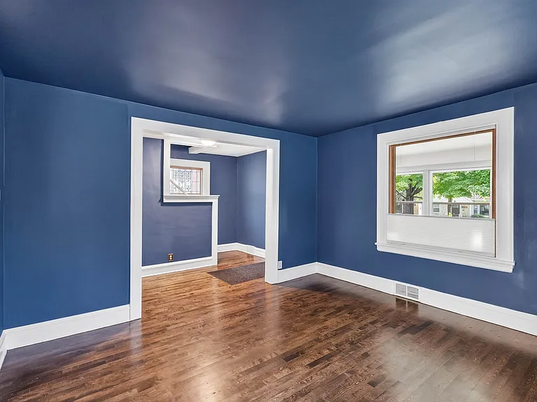 Spacious Living Room featuring gorgeous hardwood floors and large windows.