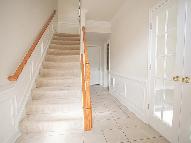 Entryway, view from the front door, office is on the right, half bath further down the hall