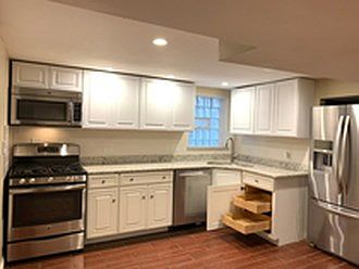 Ample counter space with a kitchen equipped with dishwasher and granite countertops.