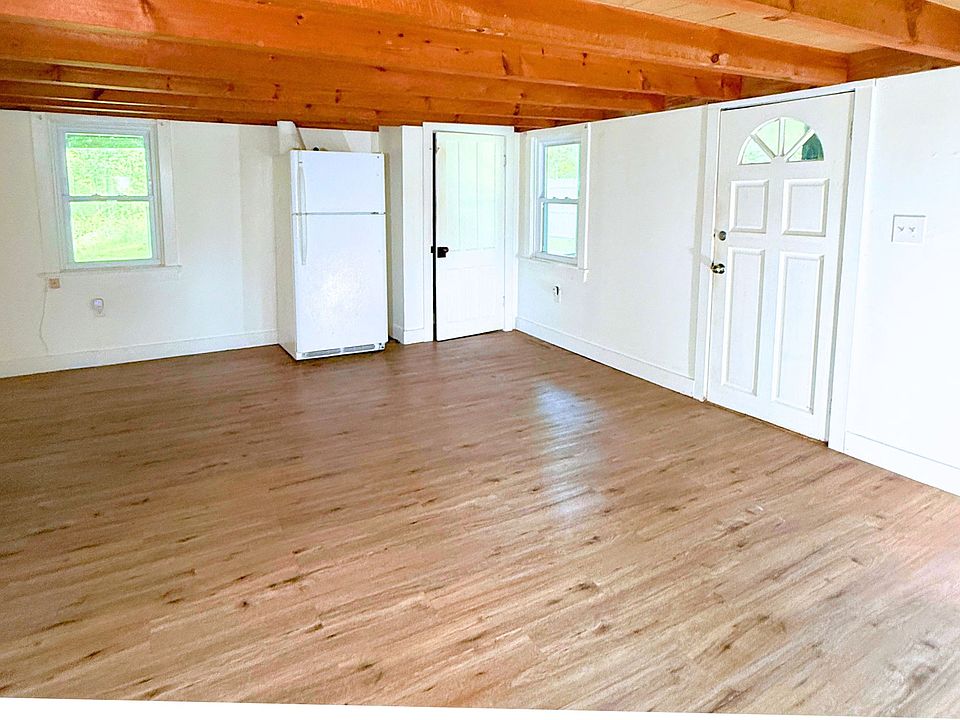 Standing in living room facing front door, closet as well as the fridge which can be moved back to kitchen or left in this current space.