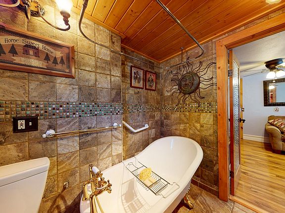 IMPORTED ITALIAN MARBLE TILE THROUGHOUT AND TONGUE AND GROOVE WOODEN CEILING