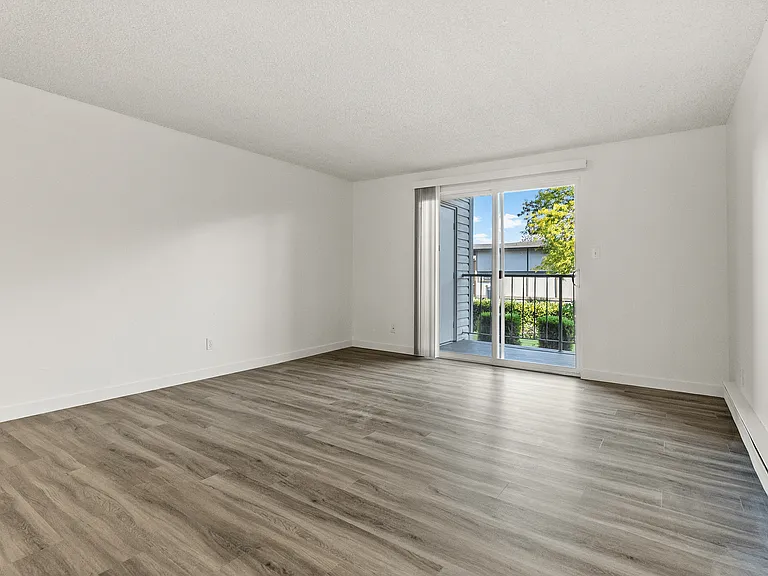 Relax in a bright, open living room featuring modern flooring and direct access to your private balcony for fresh air and natural light. Relax in a bright, open living room featuring modern flooring and direct access to your private balcony for fresh air
