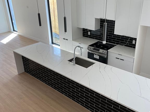 KITCHEN SHOWING FARMHOUSE SINK AND CUSTOM DESIGN