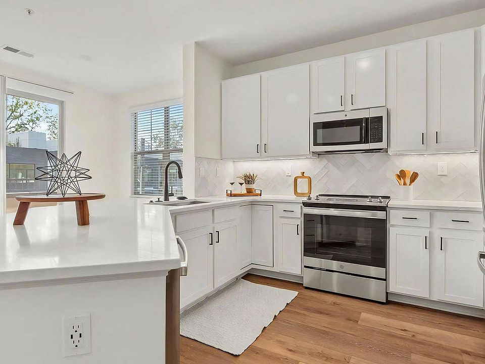 Spacious Kitchen with White Cabinets and Premium Fixtures