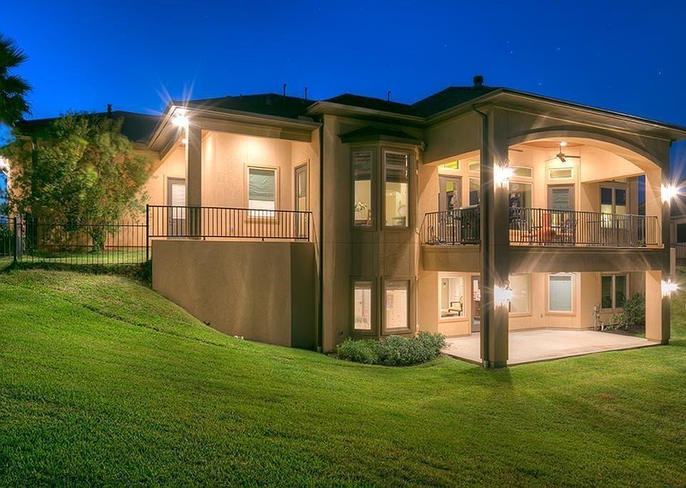 This rear view clearly shows the custom design. Special engineering, 16 piers and a unique design was necessary for a moisture proofed retaining wall and foundation on this home with no expense spared to ensure perfect conditions at all times.