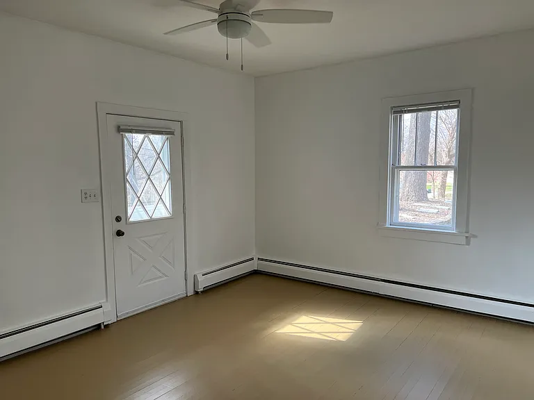 Living Room.
2- windows. West and North facing.
Reversible ceiling fan.
Hardwood flooring.
Baseboard heat.