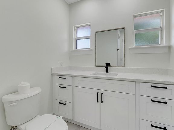 Quartz countertops and wood shaker cabinets.
