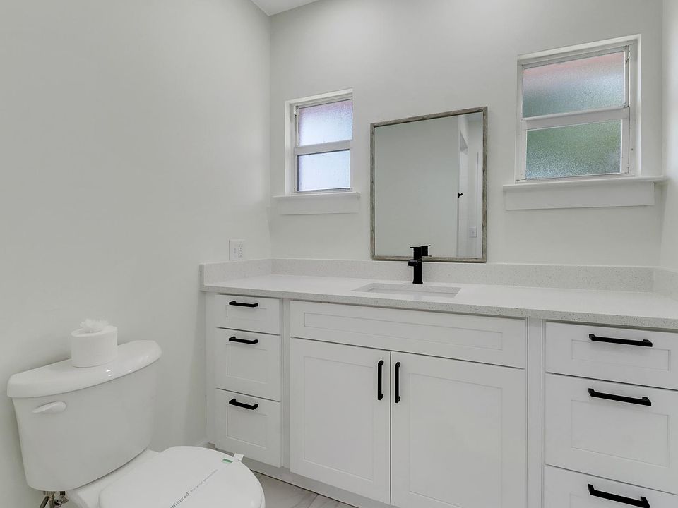 Quartz countertops and wood shaker cabinets.