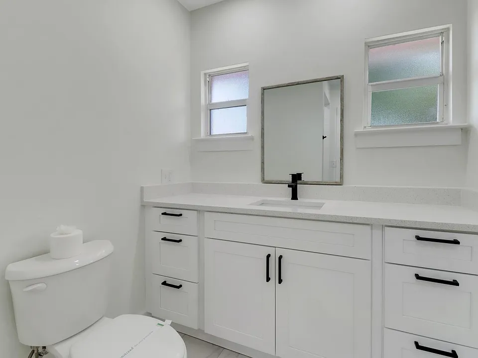 Quartz countertops and wood shaker cabinets.