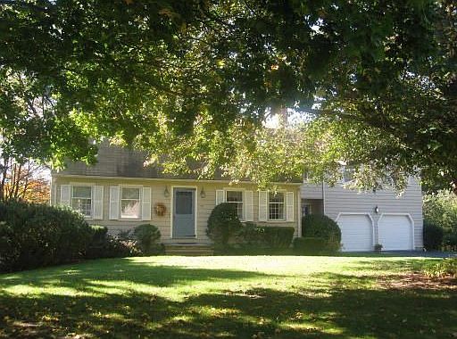 The main house has a gambrel roof, a 2 car garage and plenty of off street par