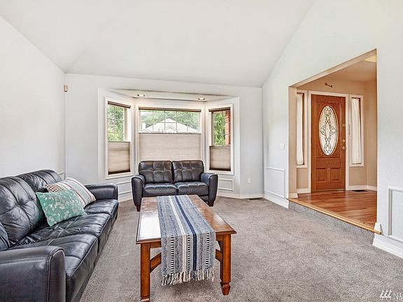 Formal living room with bay window, vaulted ceiling