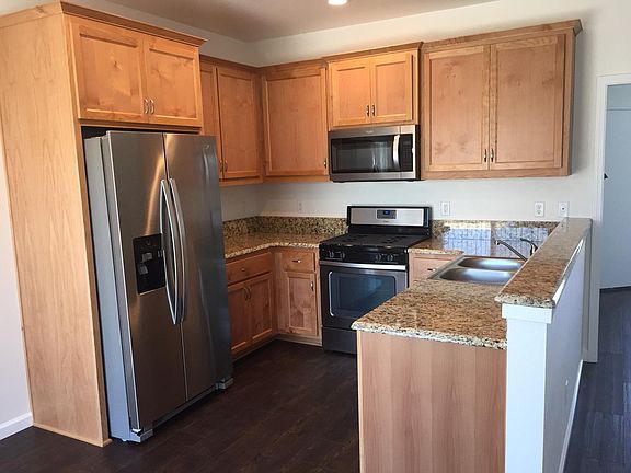 Warm wood cabinets, granite countertops, stainless steel appliance