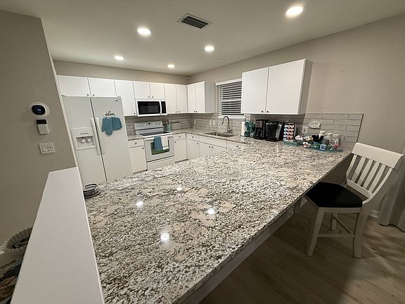 You'll love the overhead recessed lights on dimmer switches throughout the garage and house, but especially in the kitchen while you cook. The gigantic island is perfect for puzzles, crafts, sewing, painting, cooking or entertaining.