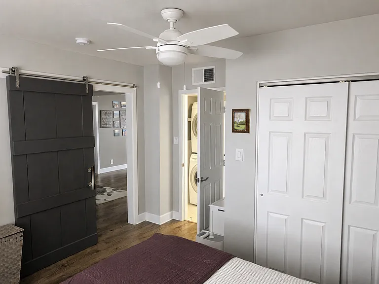 Master bedroom looking into laundry/bathroom on right and into living room on left
