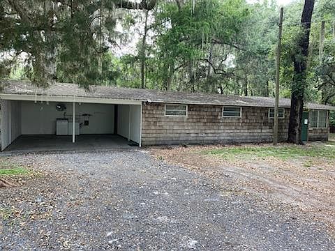 Front of house with carport view without cars, washer and dryer shown