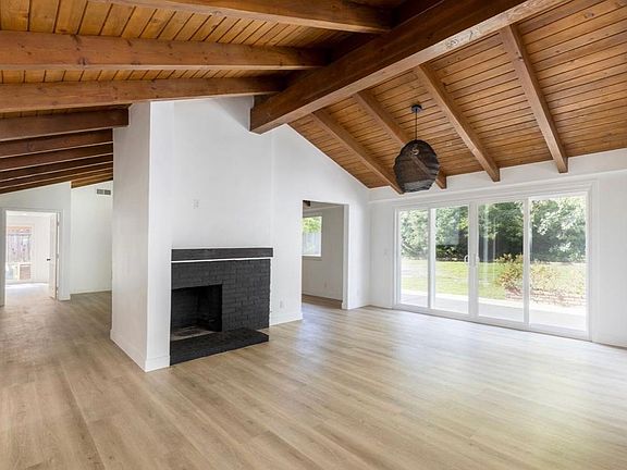 Kitchen open to fireplace, dining and sitting area. Fireplace is dual sided and into adjacent large living room