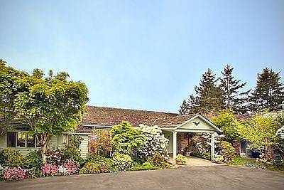 Mature landscaping surrounds the home