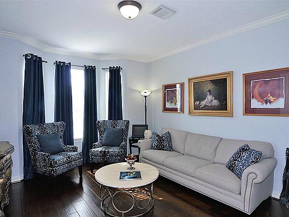 Rich wood flooring in the formal living area complements every color scheme.