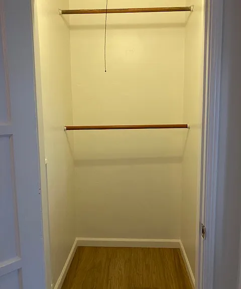 Closet in bedroom provides space for clothing/shoe needs.
