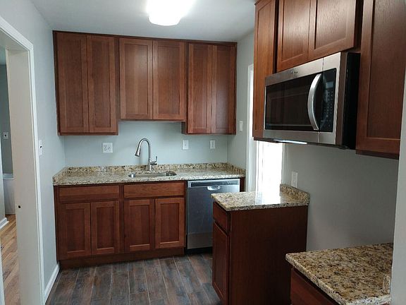 New Kitchen, cabinets, Ceramic floor, Microwave, dishwasher, Stainless steel electric stove and refrigerator not shown.