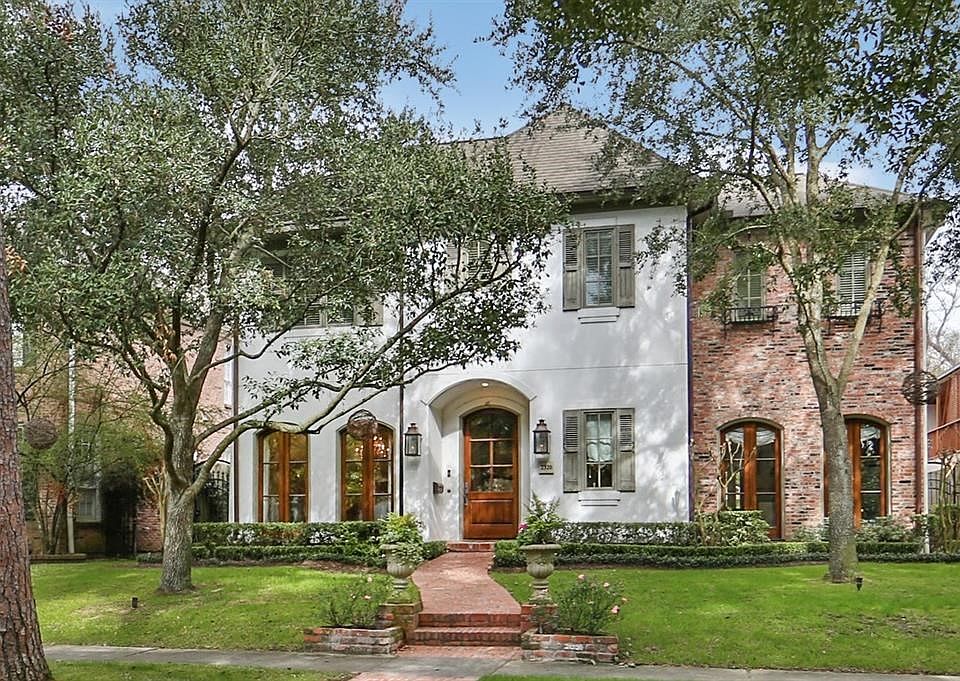 Beautiful Custom home features oil rubbed bronze gas coach lights, brick walkway, gorgeous wood windows and mature trees.