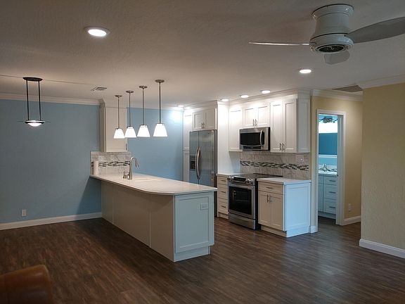 Recessed lights throughout home, plus pendants in kitchen